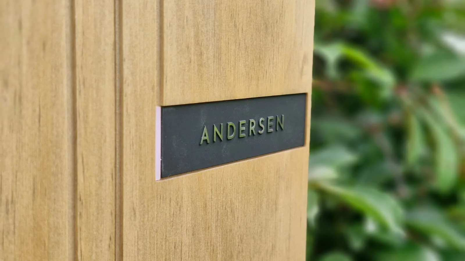 Close-up of the Andersen brass nameplate on a hardwood-fascia EV charger installed in Wakefield by Knox Power & Data