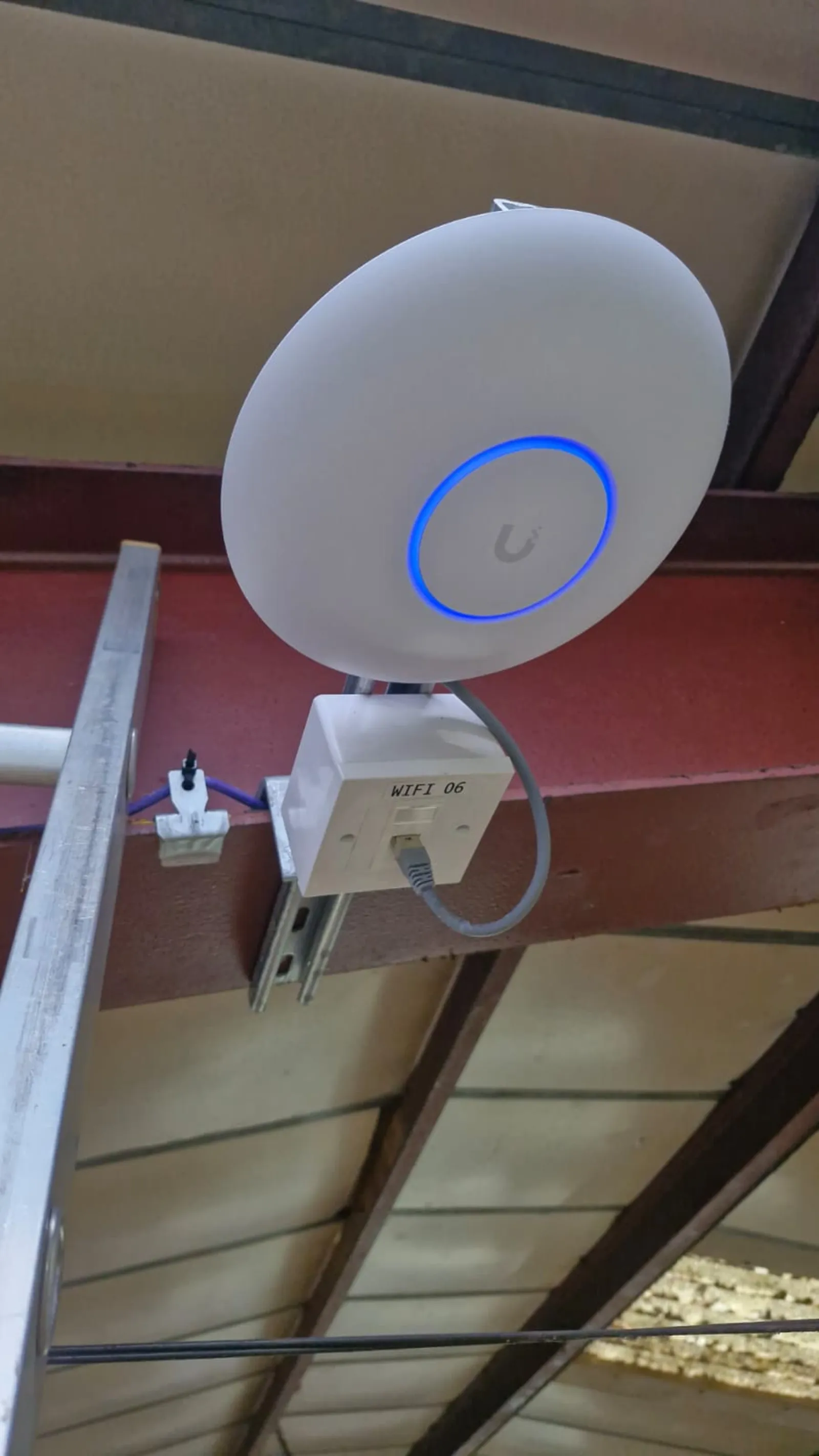 Ceiling-mounted enterprise WiFi access point fed by Cat6 cabling in Wakefield